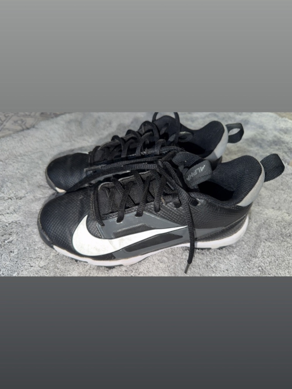 Nike Black Low-Top Kids Baseball Cleats with White Swoosh